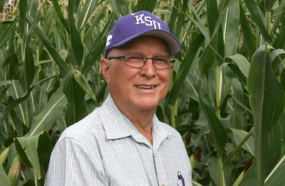 Outstanding Alumni Stahlman standing in a corn field