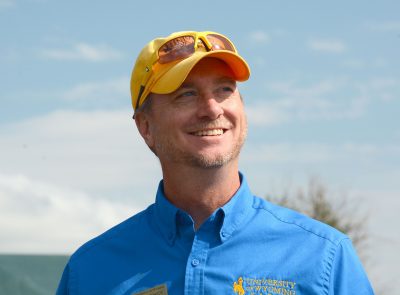 Man in hat standing in front of camera