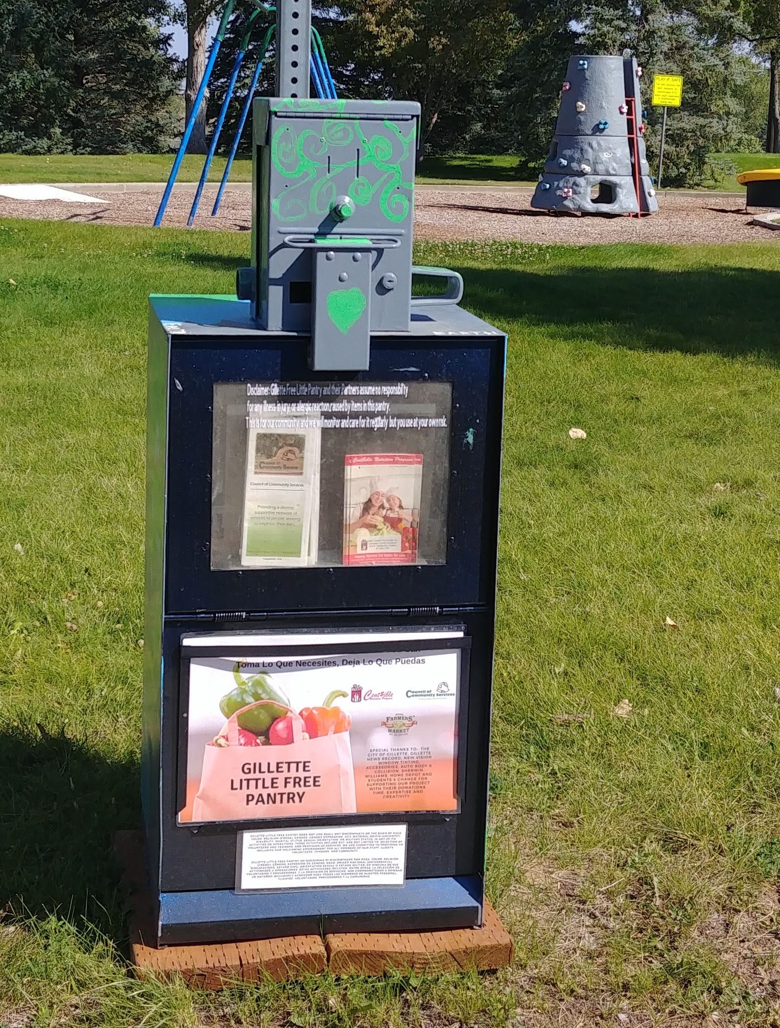 Photograph of newspaper delivery box refurbished into a mini food pantry.