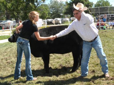 Photograph of girl, her beef entry, and the judge.