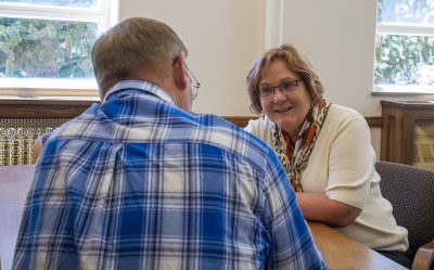 Dean Barbara Rasco visits with person.