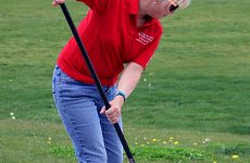 Beth Barker sweeps the sidewalk