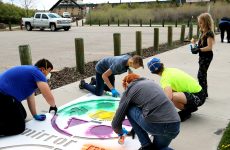 A group of boys paints the Mirror Me stencil