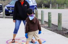 Marilee Jackson and her grandson on the Mirror Me stencil.