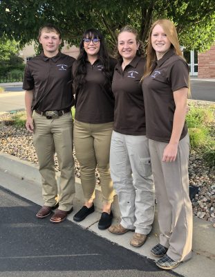 Four members of the UW meats judging team on sidewalk before start of Quick Bow.