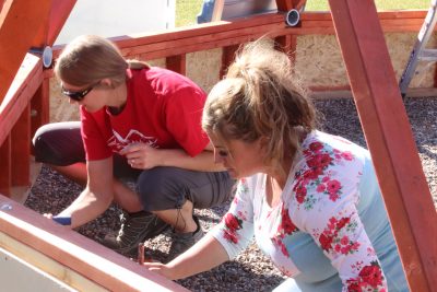 Sierra Mitchell and Shelley Balls paint the geodome base.