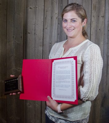 Picture of woman holding plaque