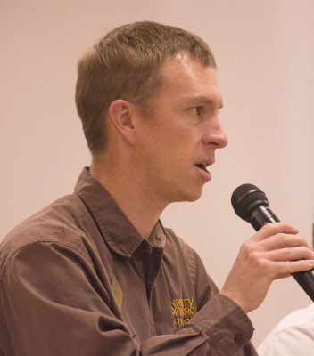 Photograph of man holding microphone