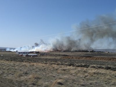 Fire and smoke on the range as seen from a distance.