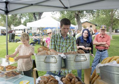 Photograph of man selling bread in park