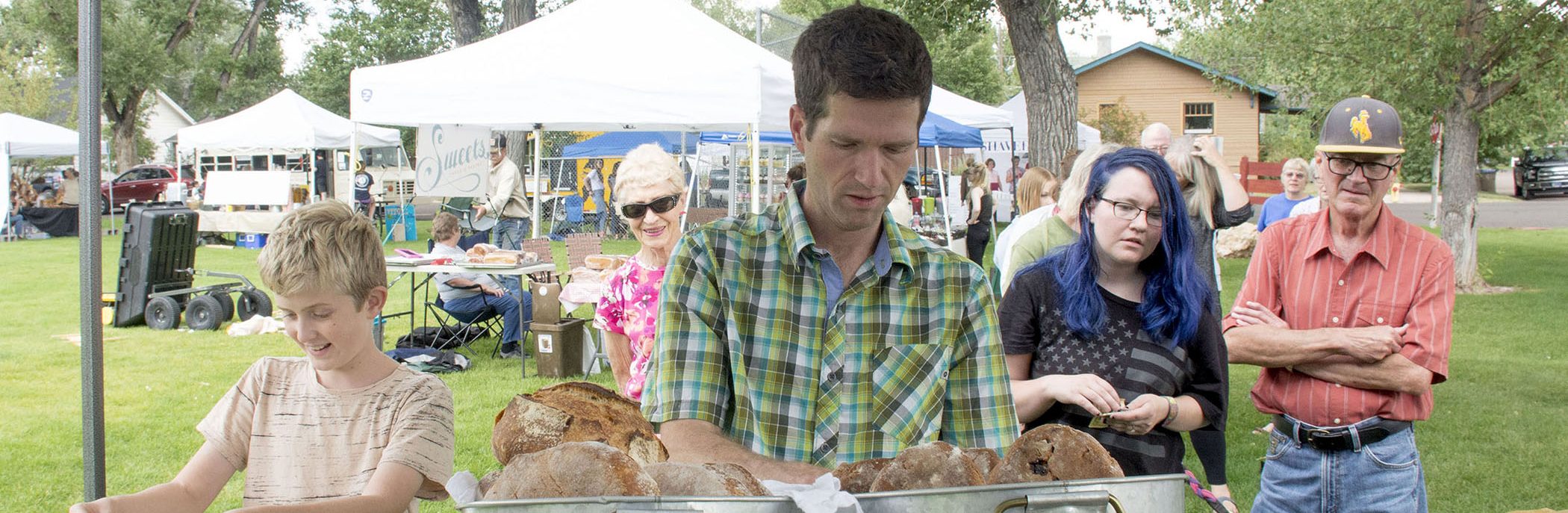 Photograph of man selling bread in park