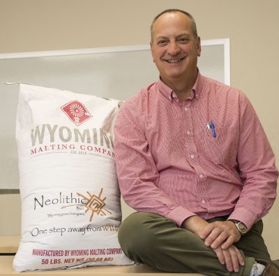 Picture of man with sack of grain on desk