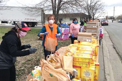 Photograph of people next to food boxes