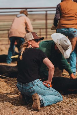 Girl kneeling down with calf