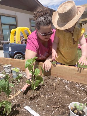 Photograph of woman and child planting vegetable