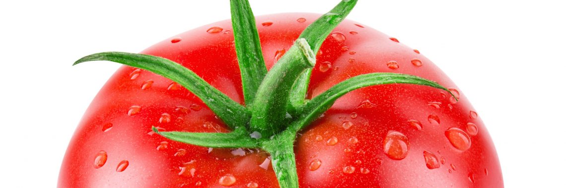 bright red tomato with green stem and water droplets