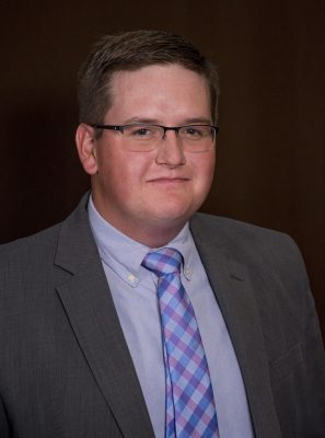 Headshot of man in suite and tie