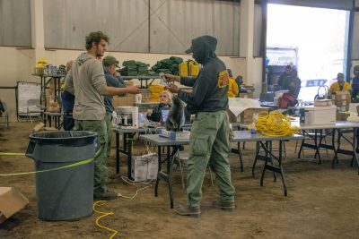 Picture of men and woman in Hansen Arena with equipment