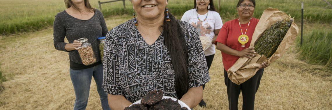 Four people holding different food items.