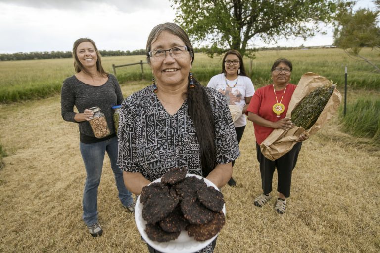 Four people holding different food items.