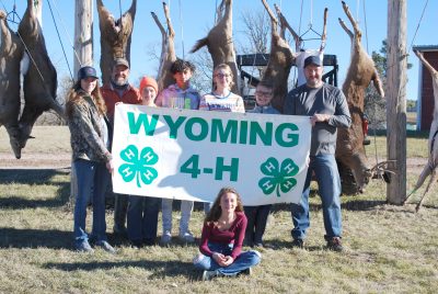 Photograph of youths and deer