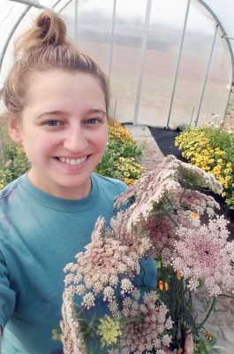 Photograph of student holding flowers