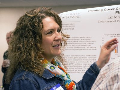 Women pointing to research poster