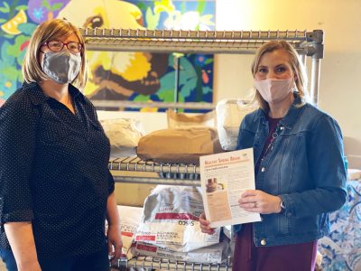 Two people in front of wheat flour bags