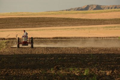 Tractor harrowing field