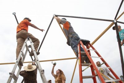 People assembling wooden structure