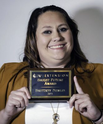 Women holding plaque