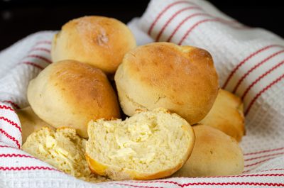 Bread rolls in a cloth-lined basket.
