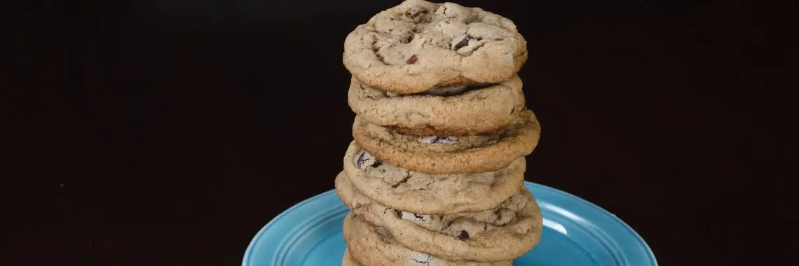 Stack of chocolate chip cookies on a blue plate.