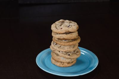 Stack of chocolate chip cookies on a blue plate.