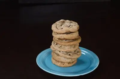Stack of chocolate chip cookies on a blue plate.