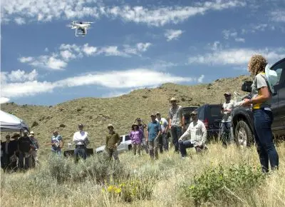 rangeland drone demonstration with people watching