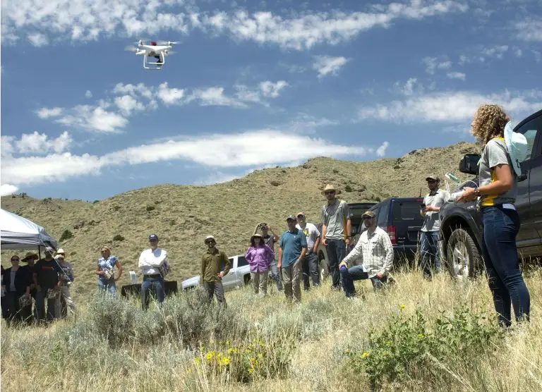 rangeland drone demonstration with people watching