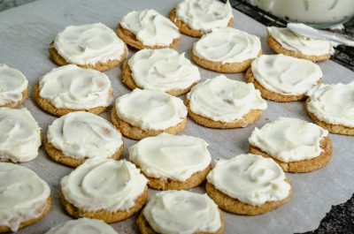 rows of frosted cookies on white parchment paper