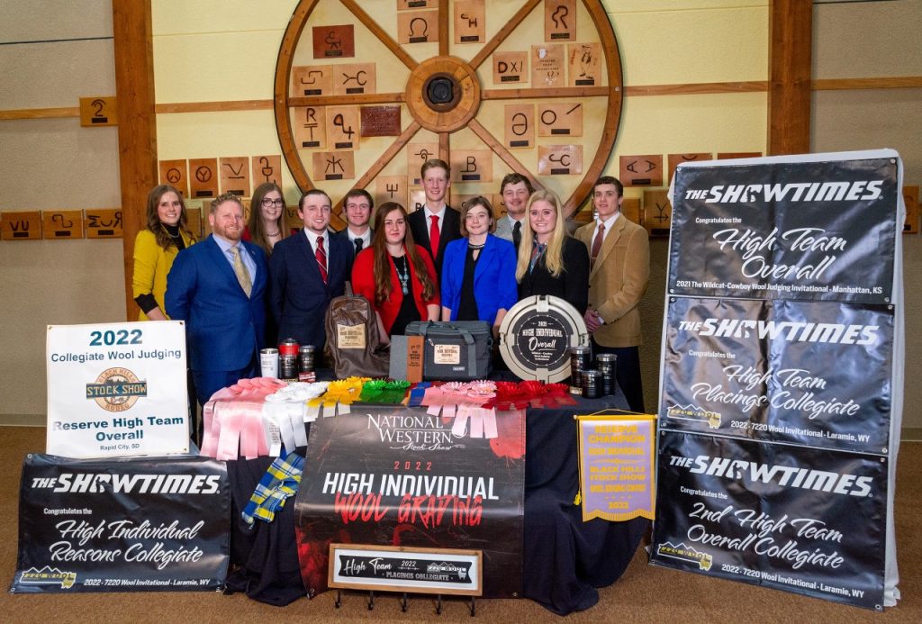 group of students and coaches with awards displayed