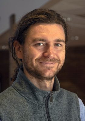 Portrait of a smiling bearded man wearing grey vest