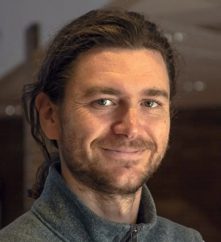 Portrait of a smiling bearded man wearing a vest