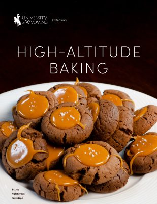 cover of the High-Altitude Baking cookbook, featuring a plate of chocolate thumbprint cookies with salted caramel filling