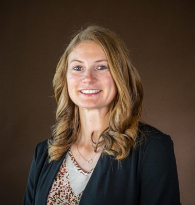 headshot of smiling woman wearing black jacket