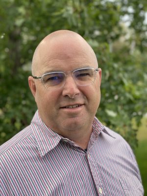 smiling bald man with glasses