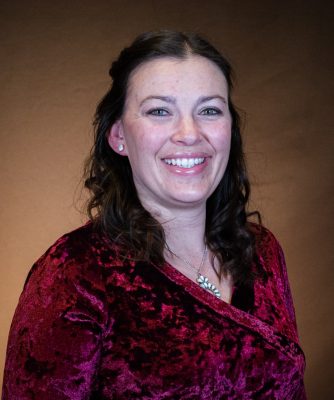 portrait of smiling woman wearing red velvet shirt