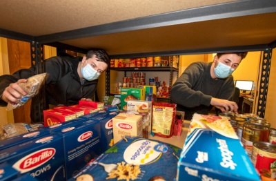 students stocking on-campus pantry