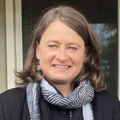 portrait of smiling woman wearing black and white patterned scarf