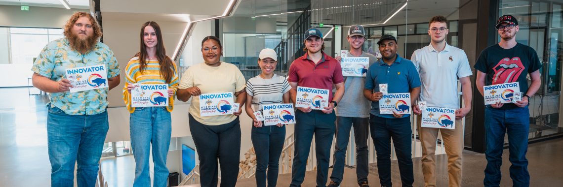 A group of students holding plaques that read, "INNOVATOR: Wyoming Innovation Partnership" along with the WIP logo, a colorful bison.