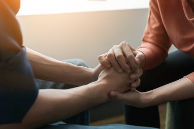 One person clasping another person's hands