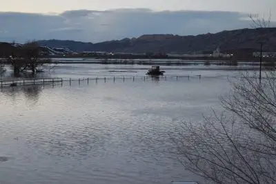 A tractor and a fence in a flooded field